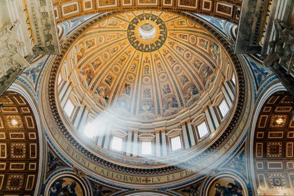 The ceiling of a large building with a dome